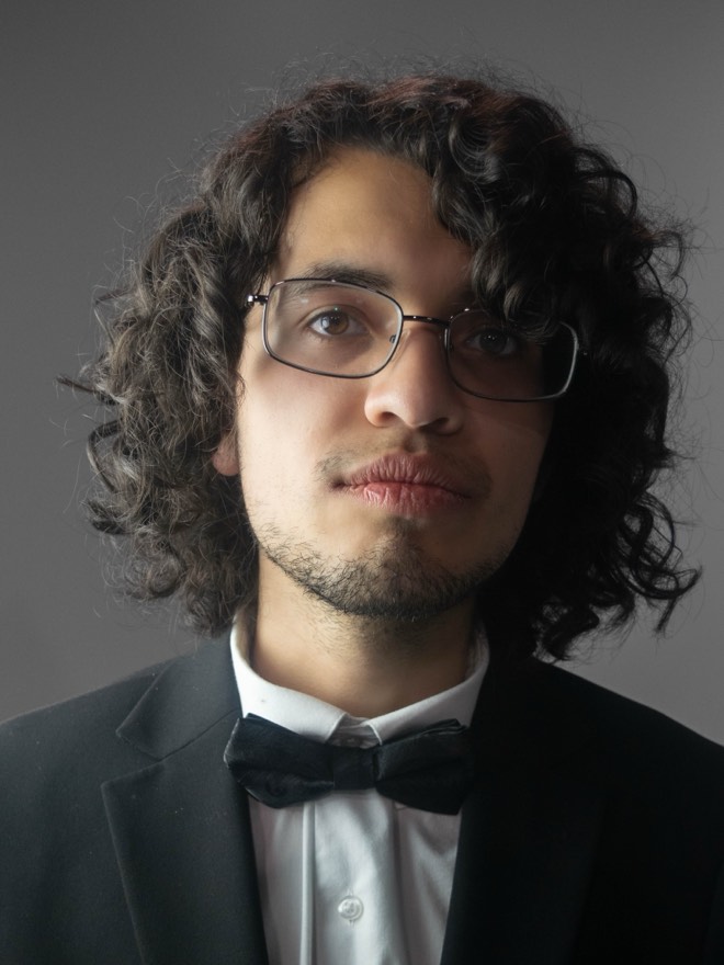 Victor in a tuxedo and bow tie, neutral expression