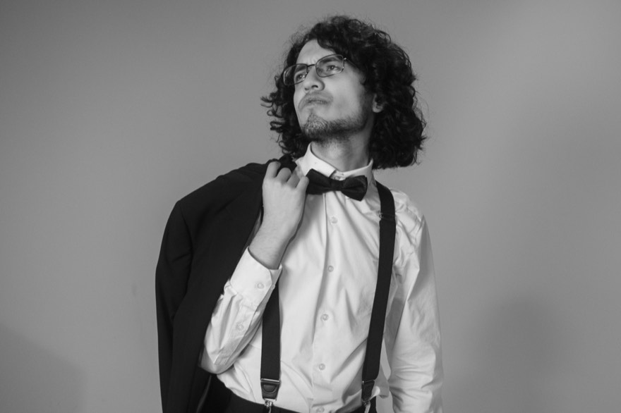 Black and white portrait of Victor with his jacket over one shoulder